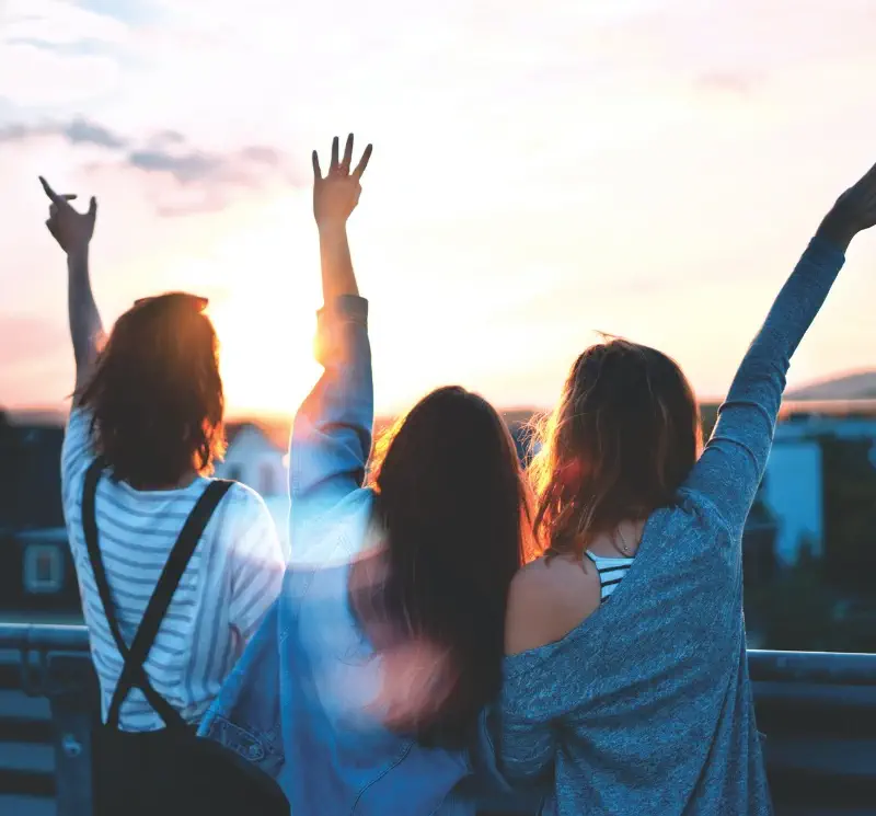 three women lifting there hands