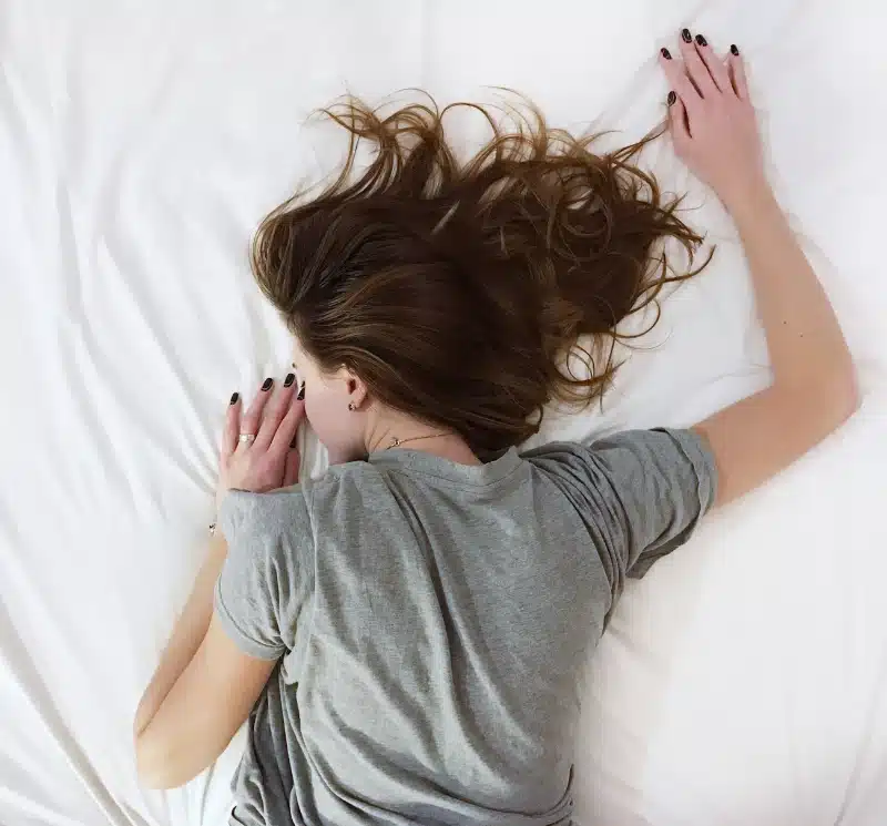 woman laying on bed photo